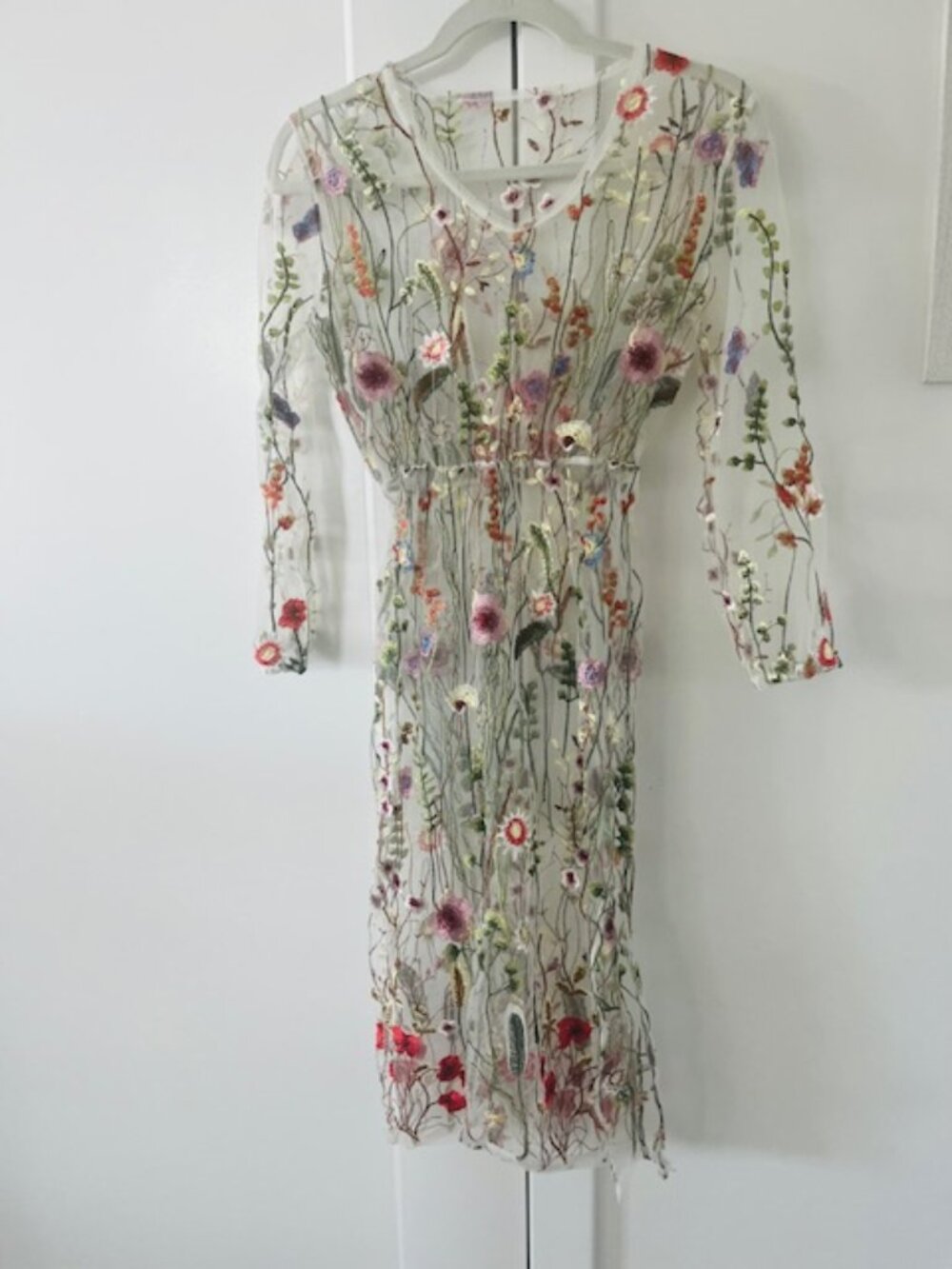 whimsical flower dress embroidery throughout. elastic waist.